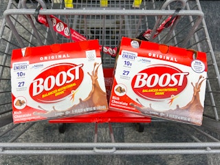 two packs of boost nutrition shakes in a shopping cart