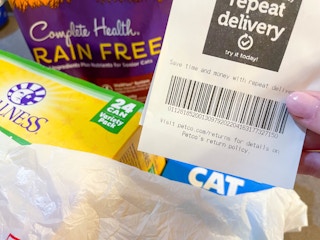 a close up of the receipt from petco in front of bag of items
