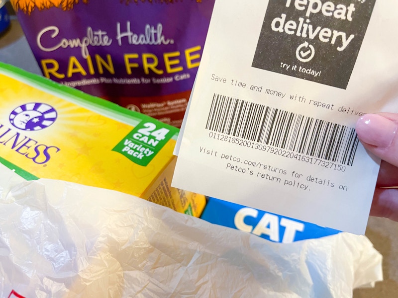 a close up of the receipt from petco in front of bag of items