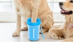 a dog with their paw in a blue paw cleaner 