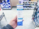hand holding bausch and lomb eye wash in walgreens