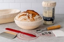 a mom and daughter using a sourdough starter kit to make bread