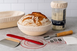 a mom and daughter using a sourdough starter kit to make bread