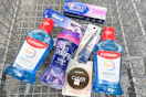 colgate, crest, oral-b, covergirl, and downy products in a cart
