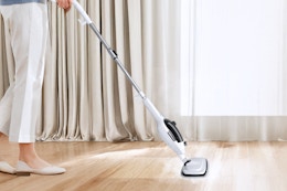 Woman using the Sprobil 11-in-1 Steam Mop on her floors.