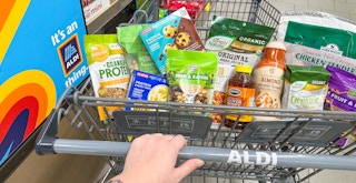Someone pushing a cart full of groceries at Aldi