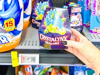 hand holding crystalynx dragons on walmart shelf