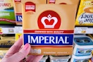 hand holding a pack of imperial butter