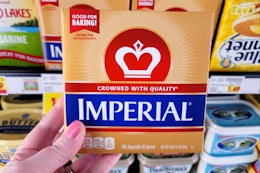 hand holding a pack of imperial butter