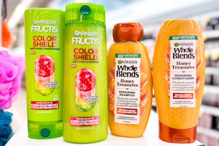 four bottles of garnier hair care on store beauty counter