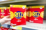 hand grabbing a box of ritz crackers