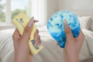 a woman squeezing squishy toys