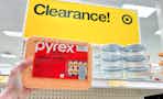 hand holding a pyrex simply store set in front of a target clearance sign