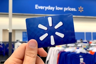 earn free gifts cards - Walmart gift card held up in store with Walmart logo in background