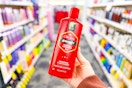 person holding a bottle of old spice shampoo in an aisle