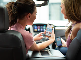 Two Ladies Looking at the KCL App on a Phone