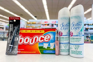 bounce dryer sheets, rimmel eye liner, lip gloss, and venus shaving cream on store counter