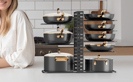 pots and pans in an organizer rack on a kitchen counter