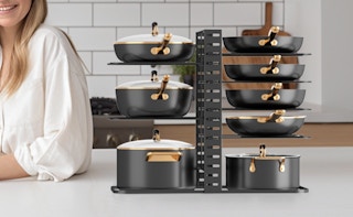 pots and pans in an organizer rack on a kitchen counter