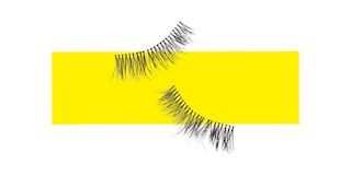 A pair of false eyelashes on a yellow collage