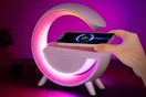 person putting phone on table lamp