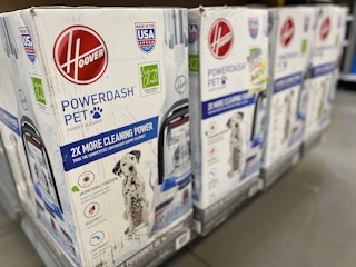 Hoover pet vacuums lined up on a shelf in Walmart