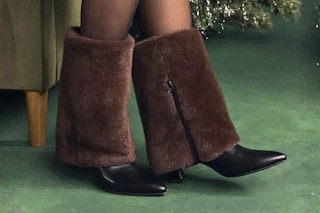 Lifestyle image of No Boundaries Women's Heeled Faux Fur Cuff Boots (worn in front of a Christmas tree)