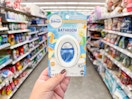 hand holding febreze bathroom air freshener in walgreens