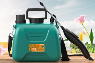 green sprayer sitting by flowers outside
