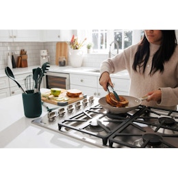 lifestyle image of a person cooking using thyme and table kitchen gadgets