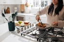 lifestyle image of a person cooking using thyme and table kitchen gadgets