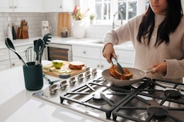 lifestyle image of a person cooking using thyme and table kitchen gadgets