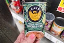 hand holding a can of siete refried beans at kroger