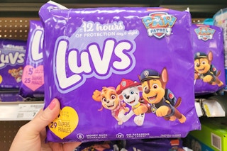 hand holding a pack of luvs diapers