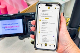 hand holding smartphone with kcl app displaying a 1-clip coupon deal