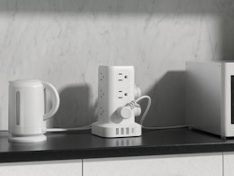 a tower surge protector on a counter with kitchen appliances
