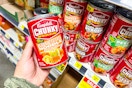 hand holding a can of campbell's soup