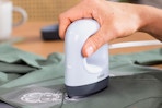 a person using a cricut mini heat press on a shirt