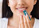 a woman putting on chapstick