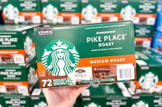 person holding a box of starbucks kcups