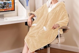 woman wearing heated throw blanket