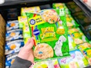 hand holding a green package of Lucky Charms cookie dough
