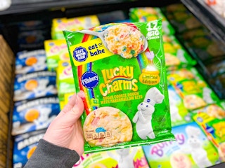 hand holding a green package of Lucky Charms cookie dough
