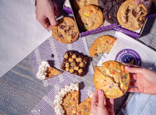 two hands grabbing cookies