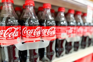 6-packs of Coca-Cola on a shelf