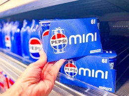 hand holding a Pepsi mini can pack