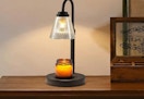 a candle lamp warmer on a wooden table 