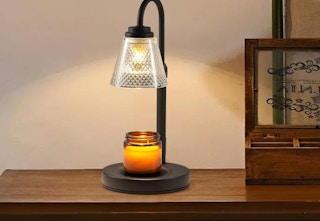 a candle lamp warmer on a wooden table 