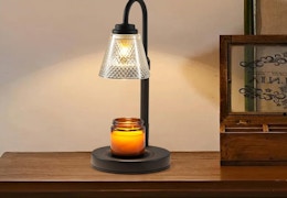 a candle lamp warmer on a wooden table