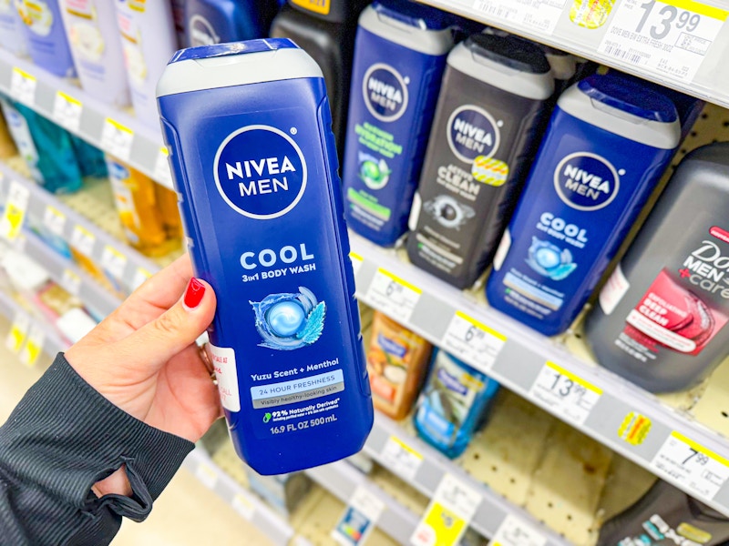 person holding nivea mens body wash by the shelf with more body wash on it